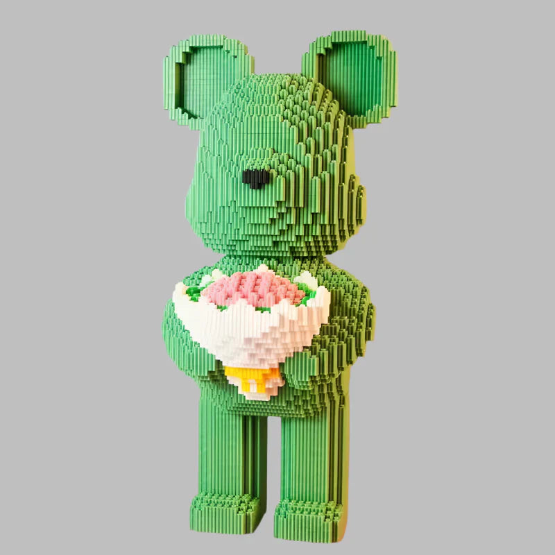 Green teddy bear made of building blocks holding flowers with measurements on a gradient background