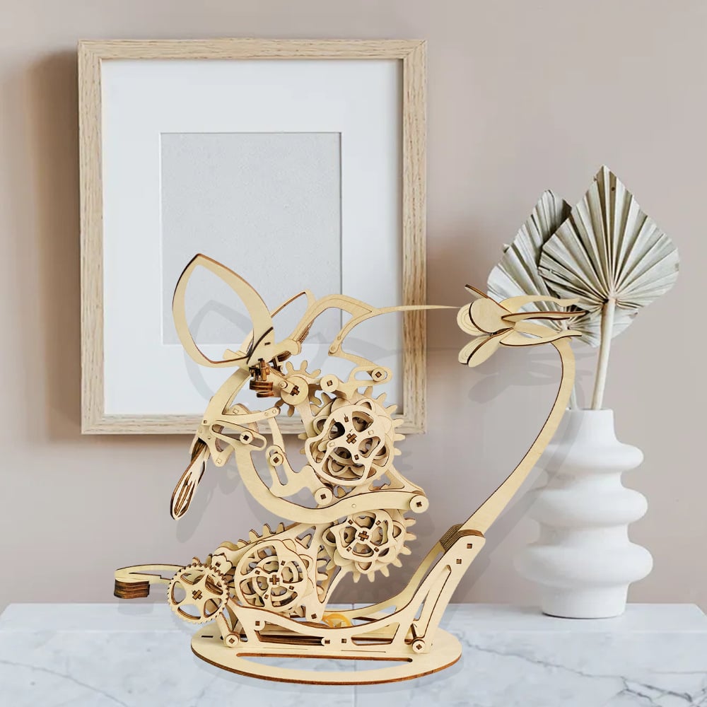 Wooden mechanical bird sculpture on a table with a framed picture DIY Puuzzle | Kinetic Hummingbird Sculpture - 3D Wooden Mechanical Puzzle Kit