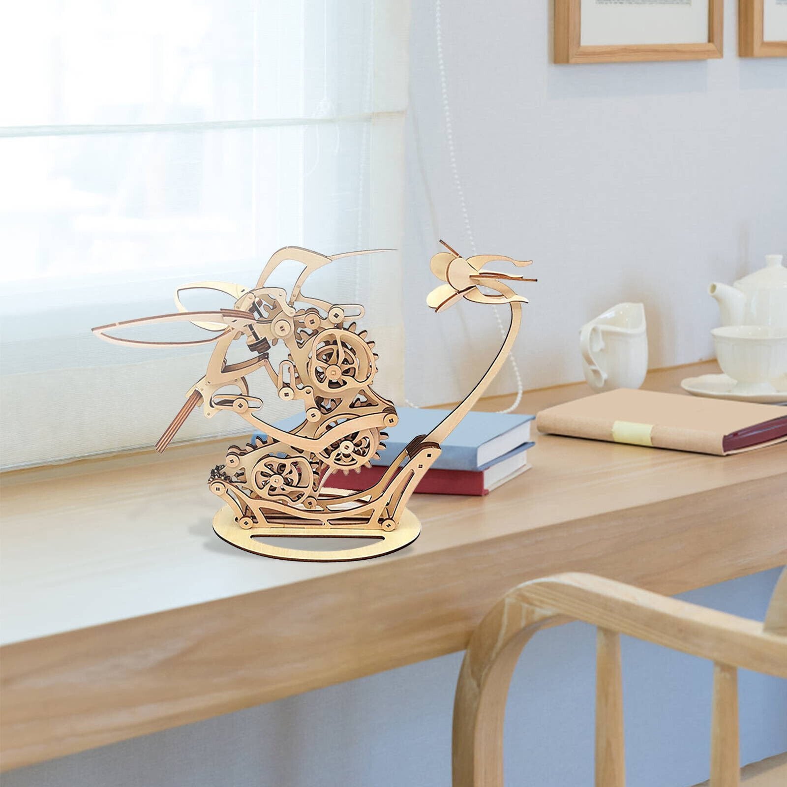 Wooden sailboat model on a desk with books and a teapot DIY Puuzzle | Kinetic Hummingbird Sculpture - 3D Wooden Mechanical Puzzle Kit