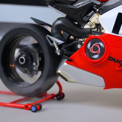 Close-up of a red and black motorcycle with 'Ducati' branding on a gray background