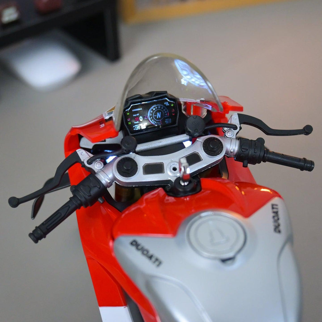 Close-up of a red and white Ducati motorcycle model with a blurred background