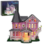 Pink Halloween-themed building set with illuminated windows and a matching box in the background.