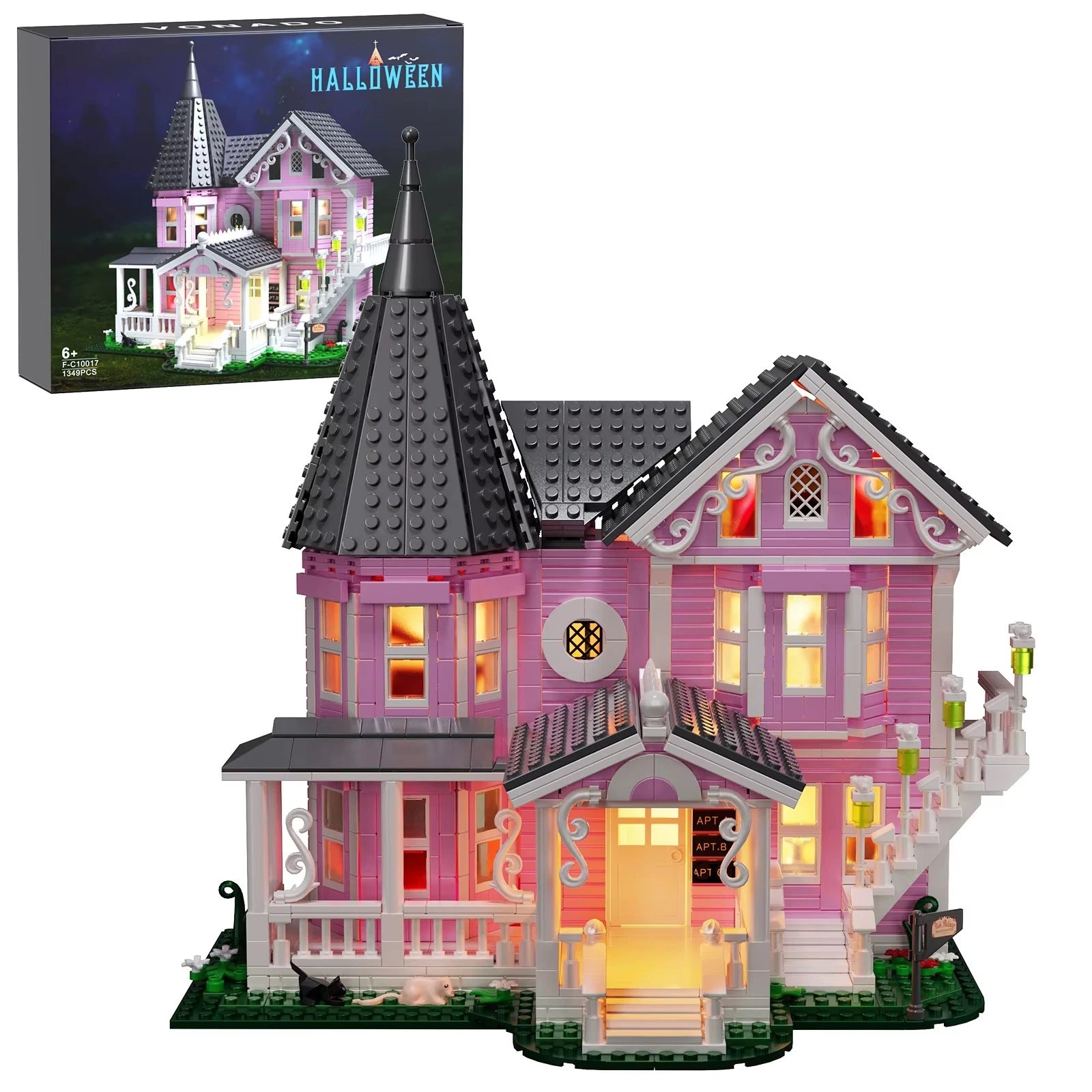 Pink Halloween-themed building set with illuminated windows and a matching box in the background.