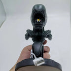 Black robot-like figure held by a hand against a white background - Unique alien creature resin lamp stand for modern home decor