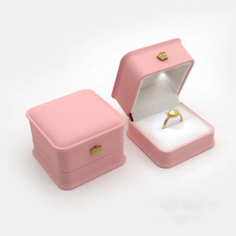 Pink jewelry box with a gold ring inside LED ring box with automatic light for engagement proposals and wedding jewelry display