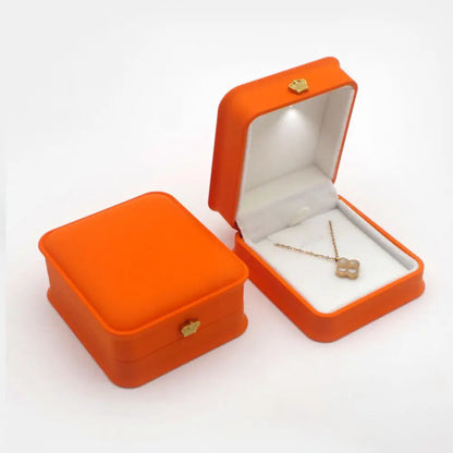 Orange jewelry box with a necklace inside LED ring box with automatic light for engagement proposals and wedding jewelry display