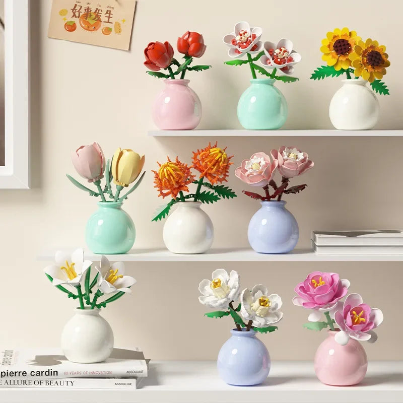 Set of small decorative vases with floral arrangements on a shelf.