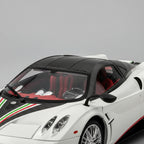 Detailed cockpit of a 1:18 Pagani Huayra model with chrome dashboard dials, carbon trim and tricolore stripe for fans, White