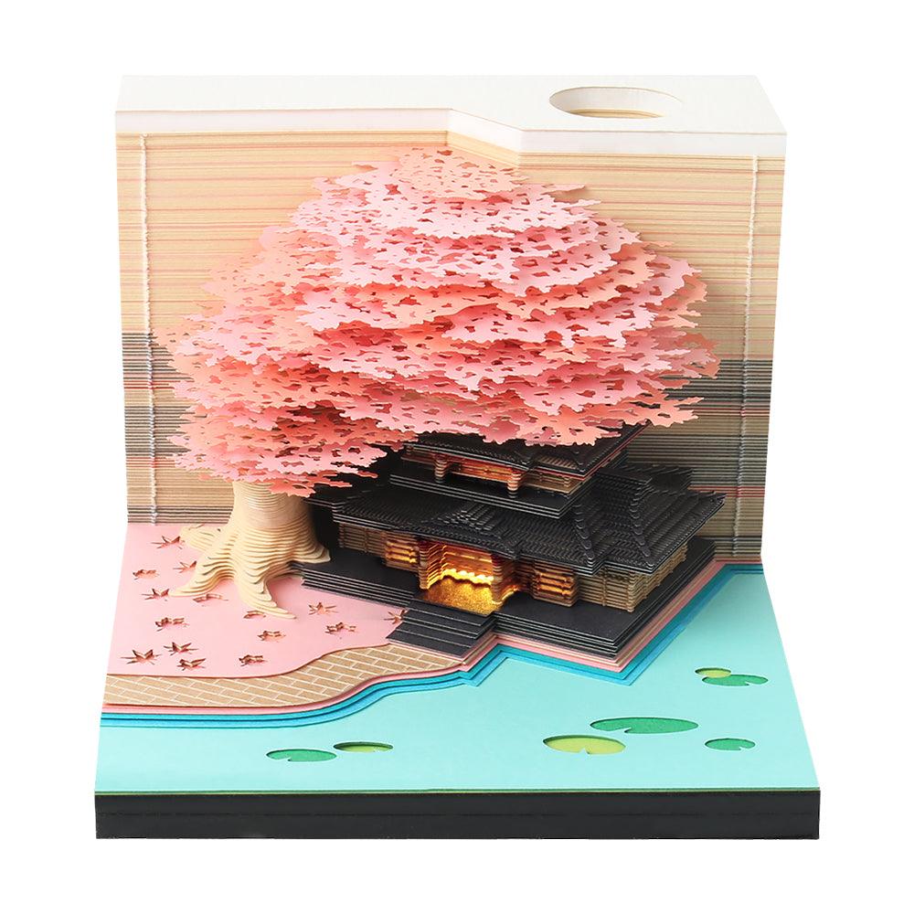 Layered note paper memo pad revealing a Castle paper sculpture, a touch LED desk ornament and daily calendar for the desk