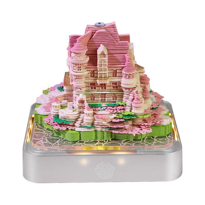 Home office decor memo pad revealing a Castle Garden paper sculpture, with a warm LED base and daily desk calendar pages
