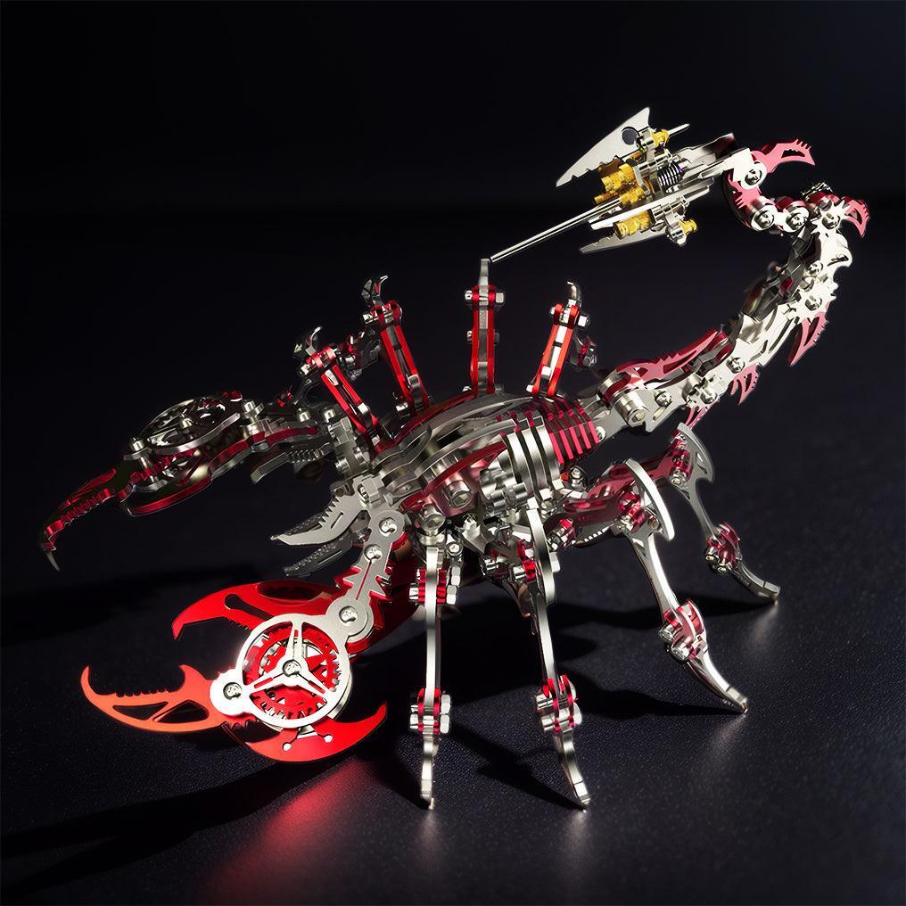 Red mechanical scorpion model with glowing accents on a dark display, a posable steel puzzle kit for desk and shelf decor