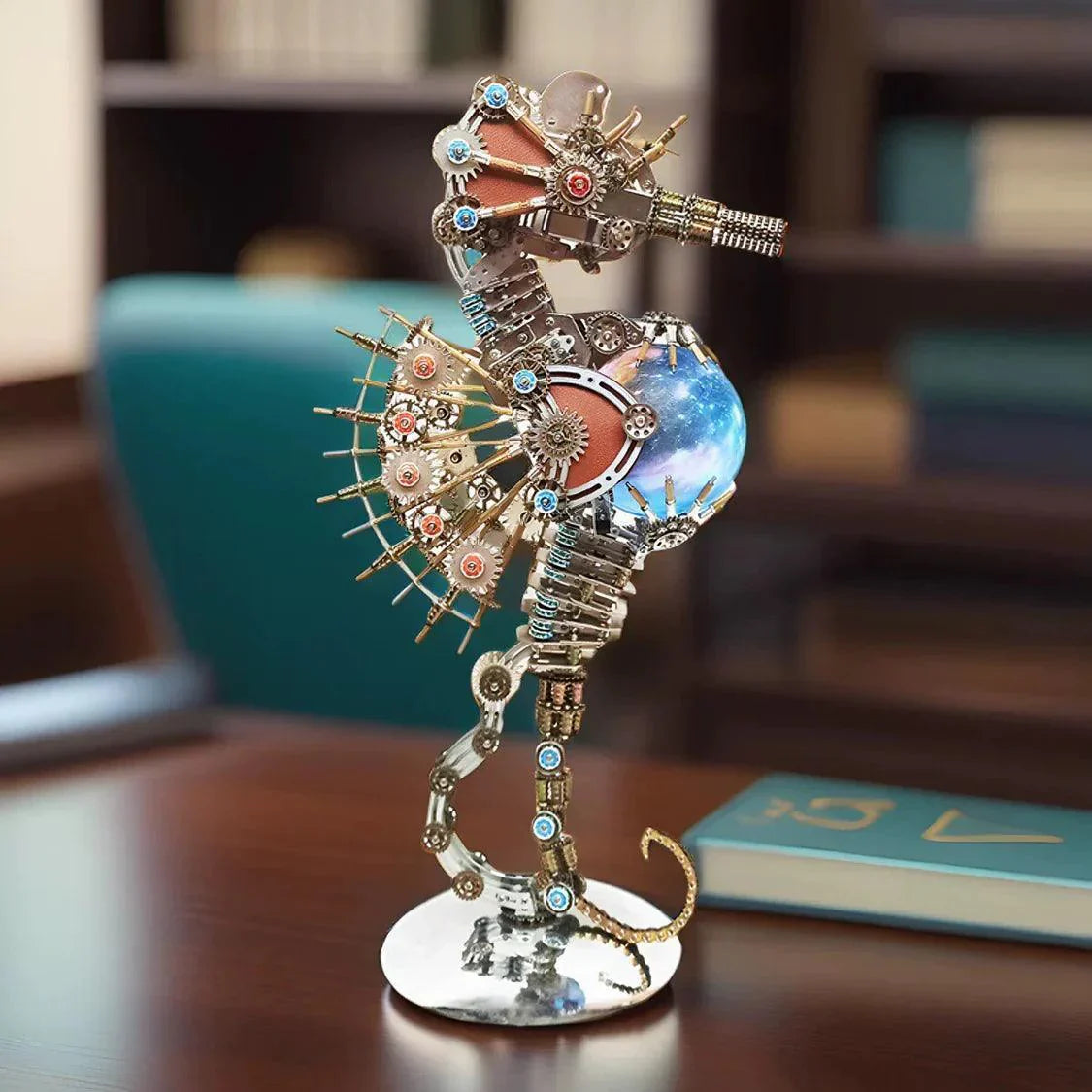 Illuminated cosmic sphere anchors this stainless steel seahorse sculpture, casting ambient light across a desk or shelf PLANET lamp.