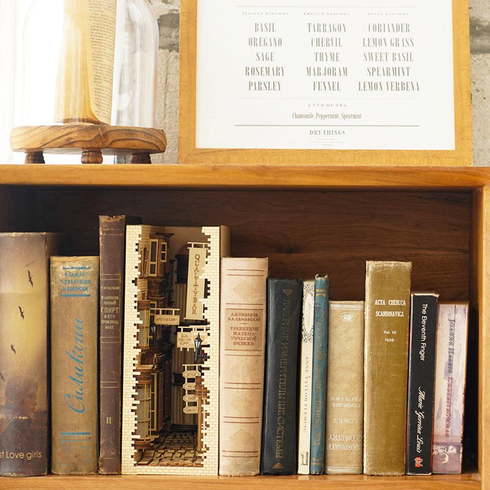 Ancient street miniature diorama book nook lit among vintage books as a cozy reading room shelf accent