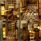 Antique shopfront signboards, glowing street lamps, and cobblestone paving on a miniature alley book nook kit