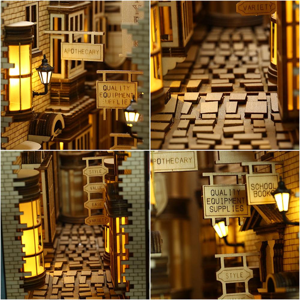 Antique shopfront signboards, glowing street lamps, and cobblestone paving on a miniature alley book nook kit