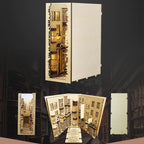 DIY book nook kit assembled from wooden and paper parts into a lamplit ancient street alley shelf insert