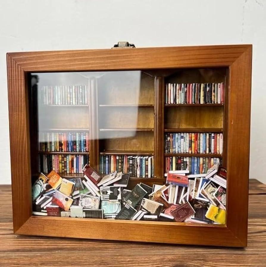 Anxiety bookshelf holding 260 mini books behind a glass front, a tactile stress relief desk decor piece for the office