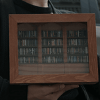 Miniature library shelf with tiny books sorted into neat rows, a calming hands on gift for book lovers and readers