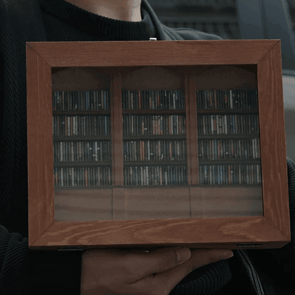Miniature library shelf with tiny books sorted into neat rows, a calming hands on gift for book lovers and readers