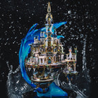 Stainless steel and gold brass Atlantis city model with a cresting wave and spire, a fantasy display piece for adult builders