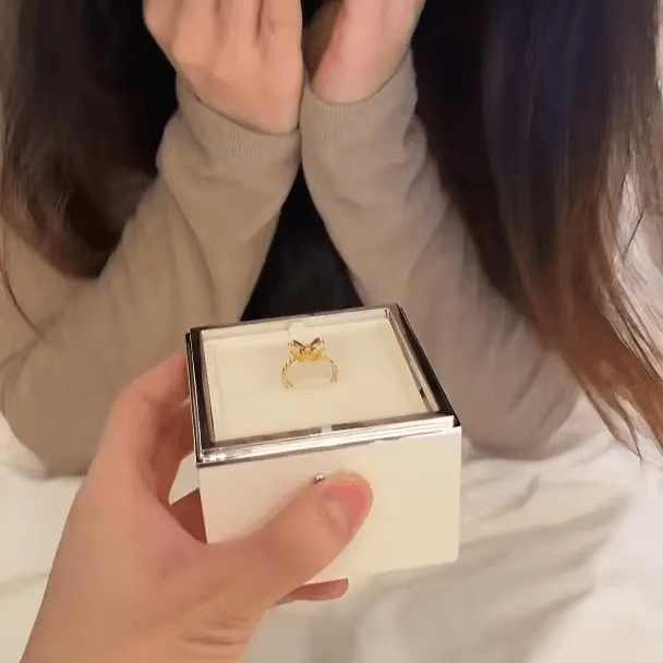 Warm white glow on open proposal ring box that frames the ring, a romantic anniversary and Valentine gift idea