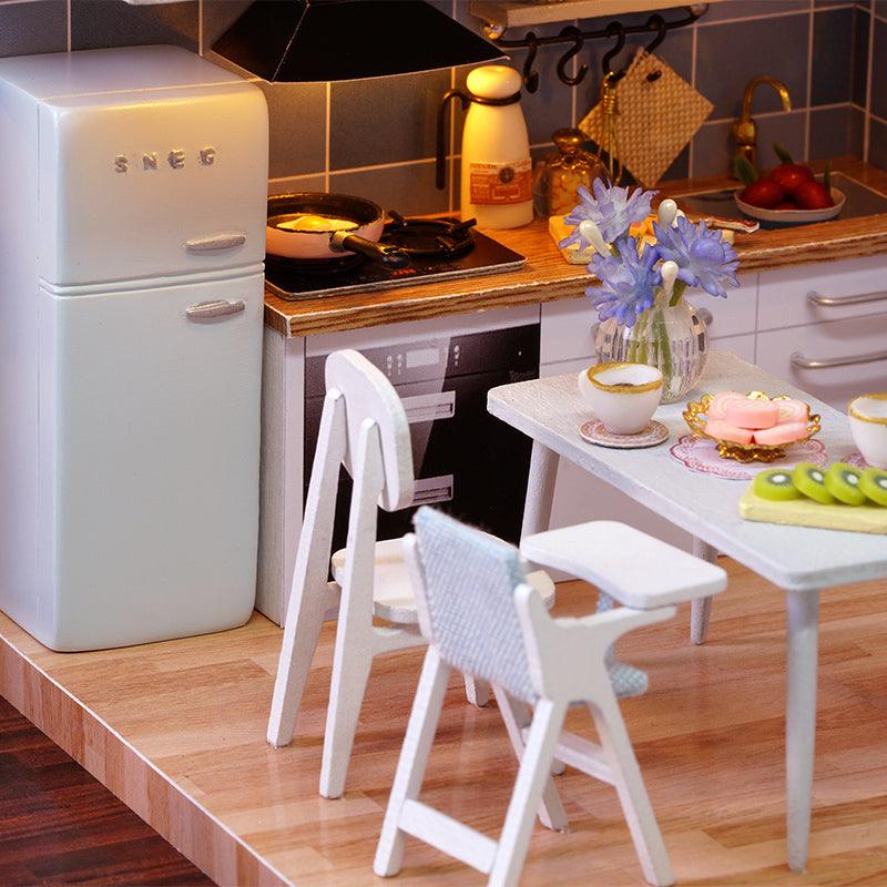 Miniature kitchen and dining nook with a retro fridge and plated food, a 1:24 furnished dollhouse kit for hobbyists
