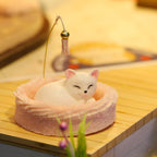 Miniature sleeping kitten figurine curled in a plush pink bed, an adorable hand assembled accent for cat cafe collectors
