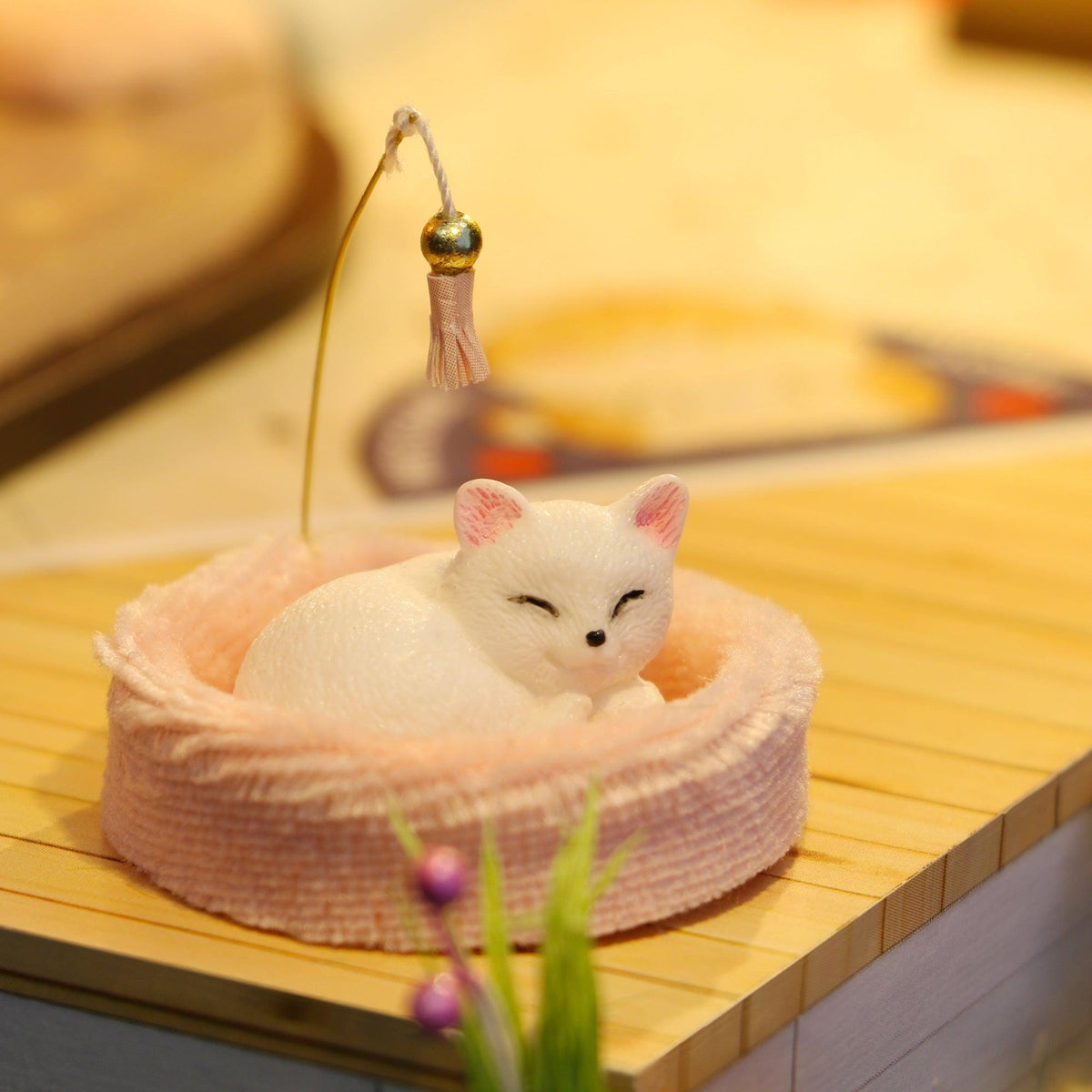 Miniature sleeping kitten figurine curled in a plush pink bed, an adorable hand assembled accent for cat cafe collectors