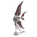 Red translucent winged angelfish metal model kit assembled on a display stand, a 500 piece stainless steel desk sculpture. Red