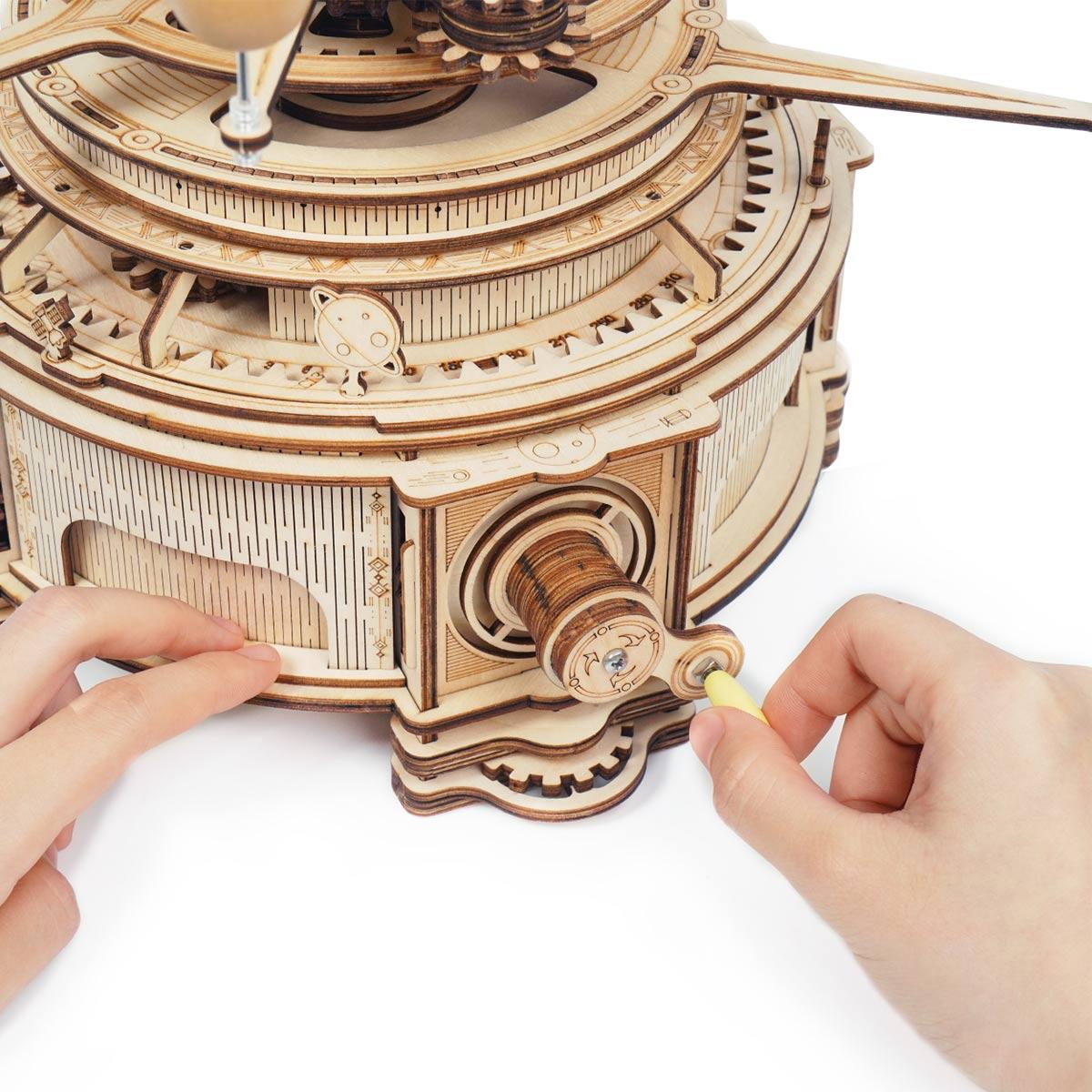 Assemble the hand-crank gear mechanism of this wooden orrery, a 316 piece 3D astronomy puzzle for adults and teens Deluxe Wooden Orbital Precision Wooden Classic
