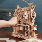 Hand-cranked wooden letterpress printing custom cards on a desk, mechanical moveable-type model kit for teen and adult crafters