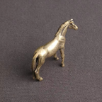 Miniature brass horse statue showing a sculpted tail and flowing mane, a vintage zodiac desk ornament for shelves and offices