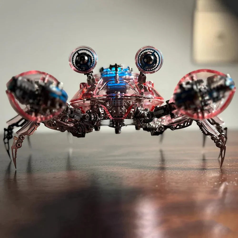 Red cybernetic crab displayed on an office desk, a poseable metal model kit and build it yourself gift for model kit fans Red