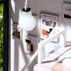 Built in LED pendant lamp lighting the miniature loft interior at night, a dollhouse apartment kit in Green, Blue and Pink accents