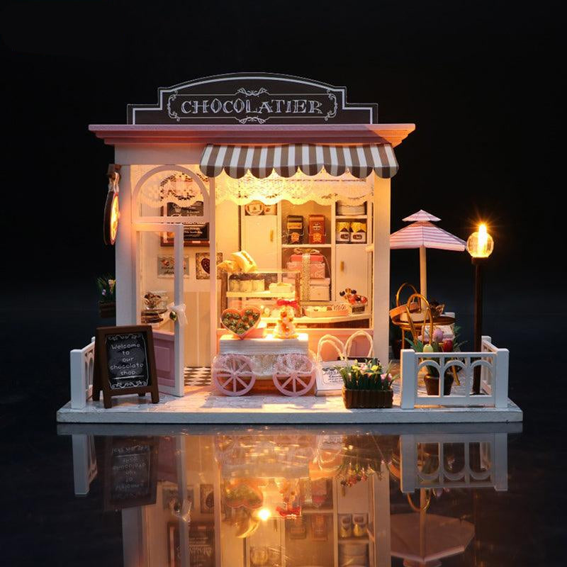 DIY miniature dollhouse kit that builds a warm LED lit chocolate shop scene for adult crafters and home shelf display