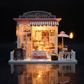 DIY miniature dollhouse kit that builds a warm LED lit chocolate shop scene for adult crafters and home shelf display