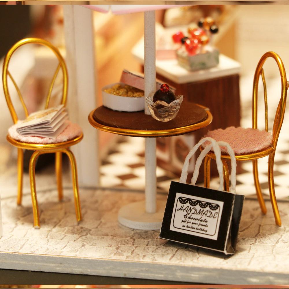 Miniature chocolate shop room box with a tiny bistro table and chairs, a 1:24 scale craft kit for adult hobbyists
