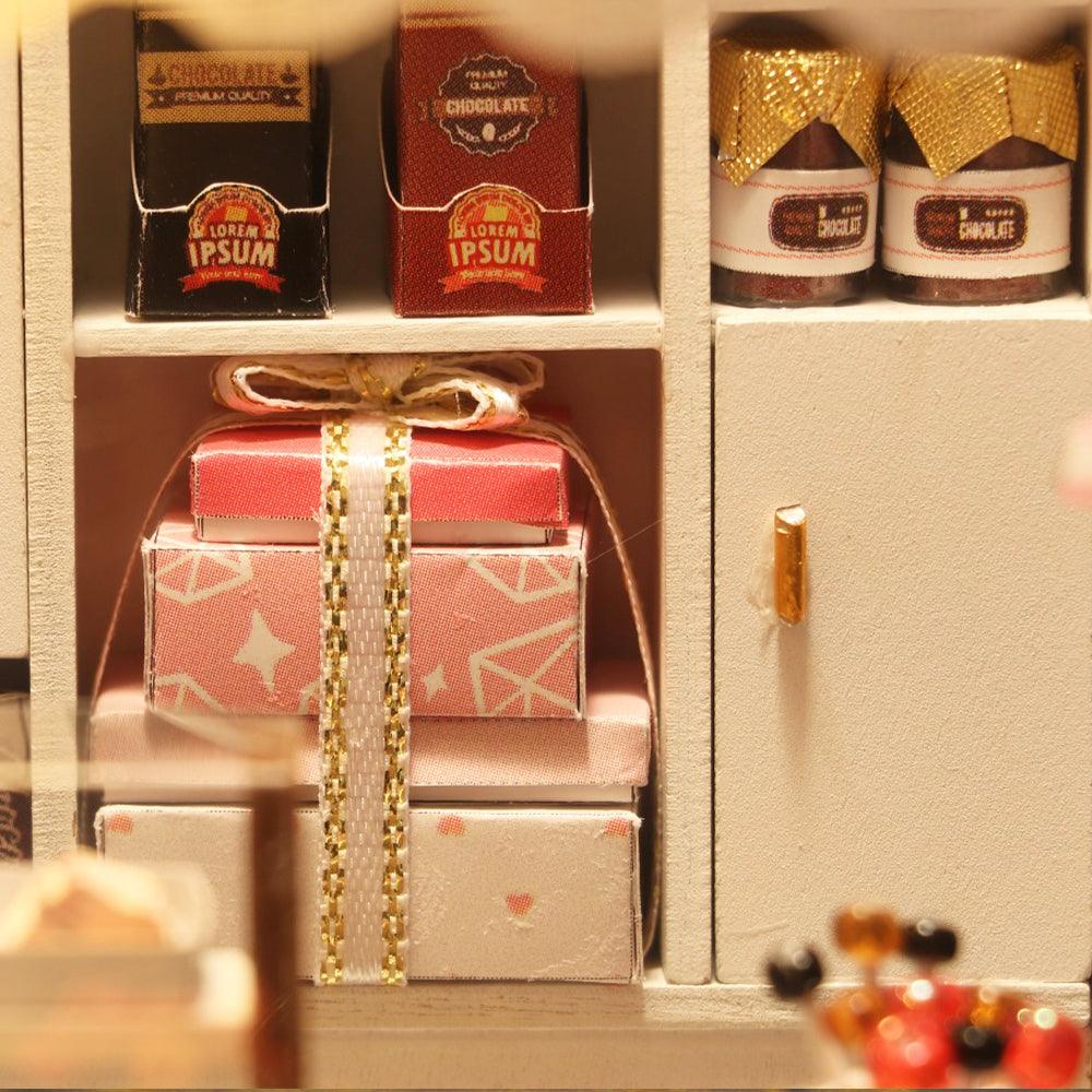 1:24 dollhouse chocolate shop stocked with miniature candy boxes and gift wrapped parcels for diorama collectors