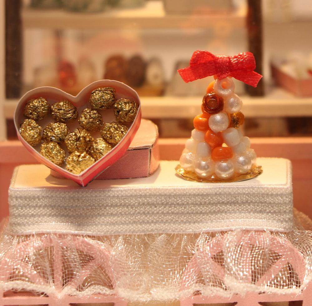 Handmade chocolatier miniature display with a heart shaped chocolate box, a detailed craft gift for dollhouse fans