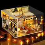 Miniature dollhouse with built-in LED lighting and a music box for a warm glowing cozy home ambiance
