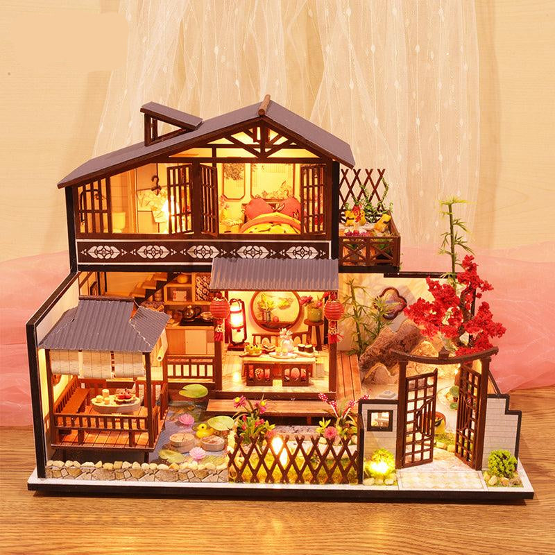 DIY dollhouse kit that builds a landscaped Japanese garden with a red maple tree and lily pond for miniature hobbyists