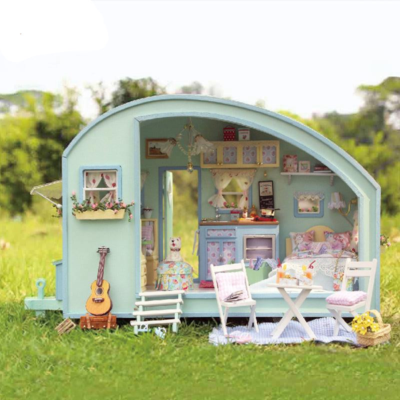 DIY miniature caravan kit that builds a mint green vintage camper with an outdoor picnic scene, a 1:24 model for adults