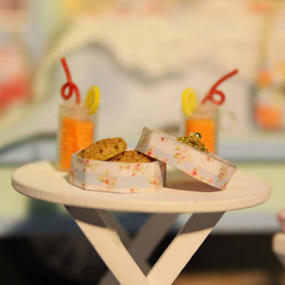 Miniature picnic table with tiny drinks and snacks beside the camper, an outdoor caravan vacation scene to build by hand