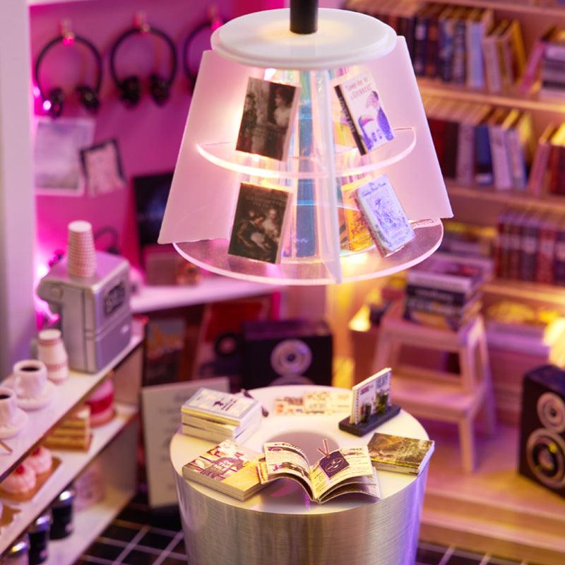 Cozy miniature reading nook with a book display lamp and coffee table, a DIY dollhouse craft kit for hobbyists and gifts