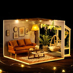 Wooden miniature house with warm LED lighting and a wind up music box that gives the finished roombox a cozy lamplit glow