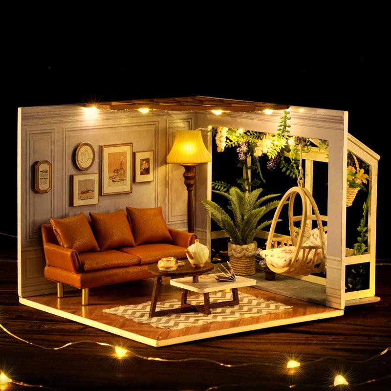 Wooden miniature house with warm LED lighting and a wind up music box that gives the finished roombox a cozy lamplit glow