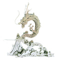 3D metal dragon puzzle assembled from stainless steel pieces on a mountain base for adult fantasy collectors Silver