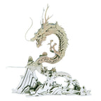 3D metal dragon puzzle assembled from stainless steel pieces on a mountain base for adult fantasy collectors Silver