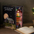 Dreamland of Alsace book nook kit glowing on a bookshelf, a lit Colmar street diorama for cozy shelf decor