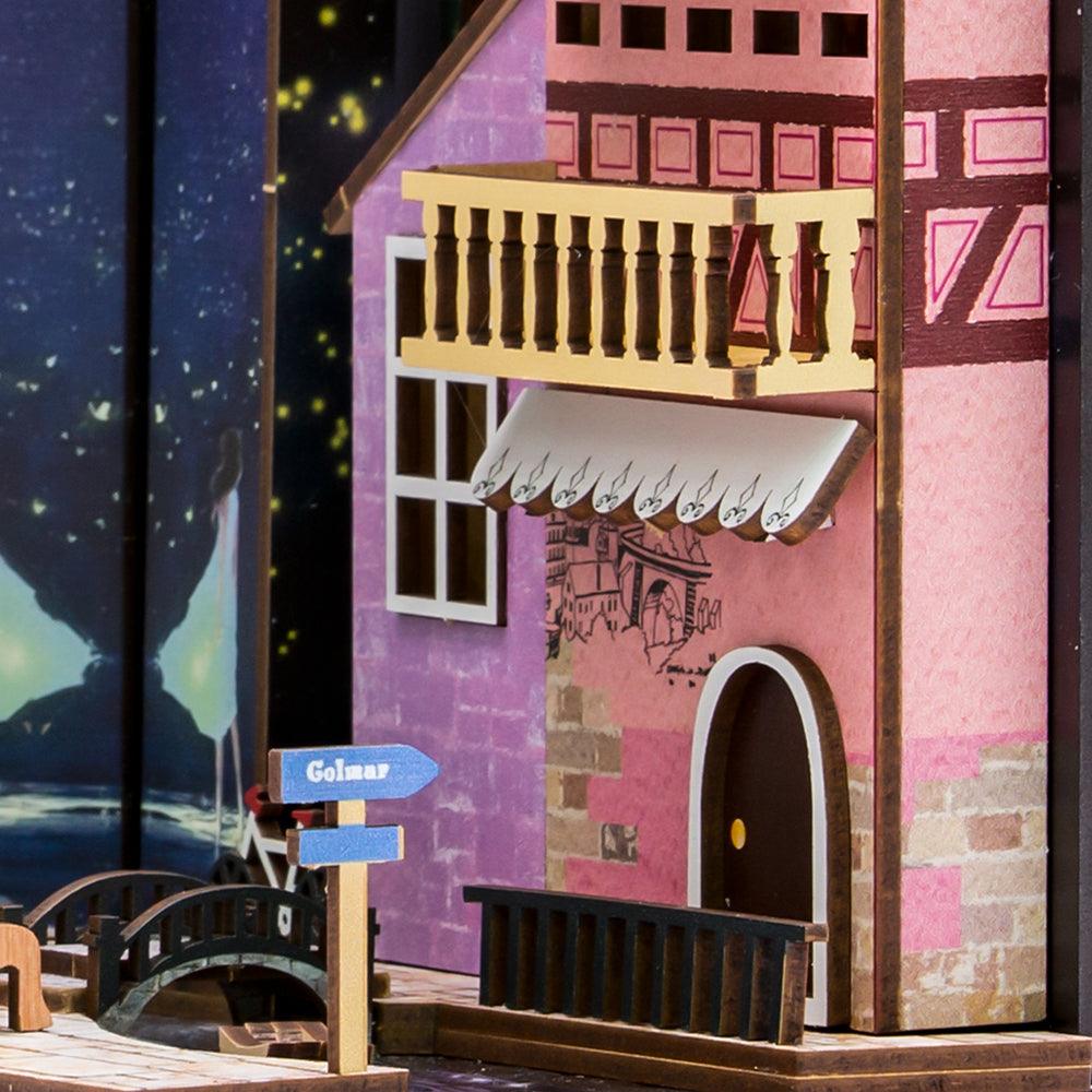 Colmar half-timbered house facade with balcony and riverside street sign in a miniature Alsace book nook insert